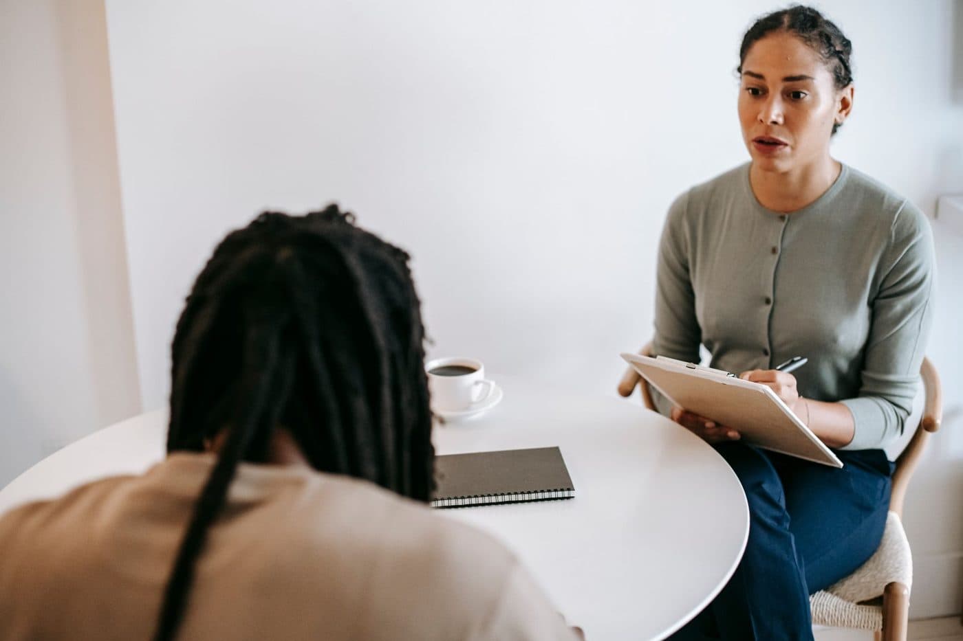A counselor and a client talking calmly at a table